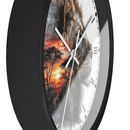 A close-up of a round wall clock with a black frame and a split-face design: one half shows a lion face, the other half shows an orange sunset landscape with trees. White clock hands and Roman numerals are visible against a light gray background.