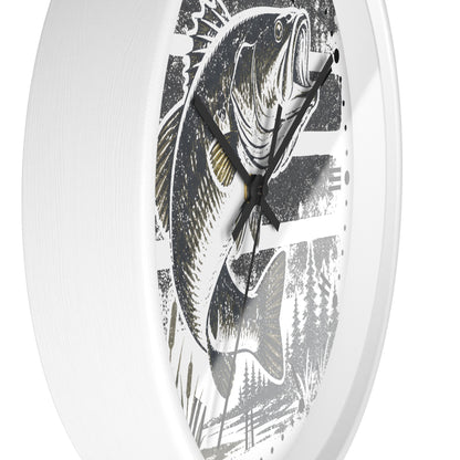 A round wall clock with a white frame and a printed fish illustration on the face. The clock shows a large black-and-white bass with gray and black brushstroke details, plus black hands.