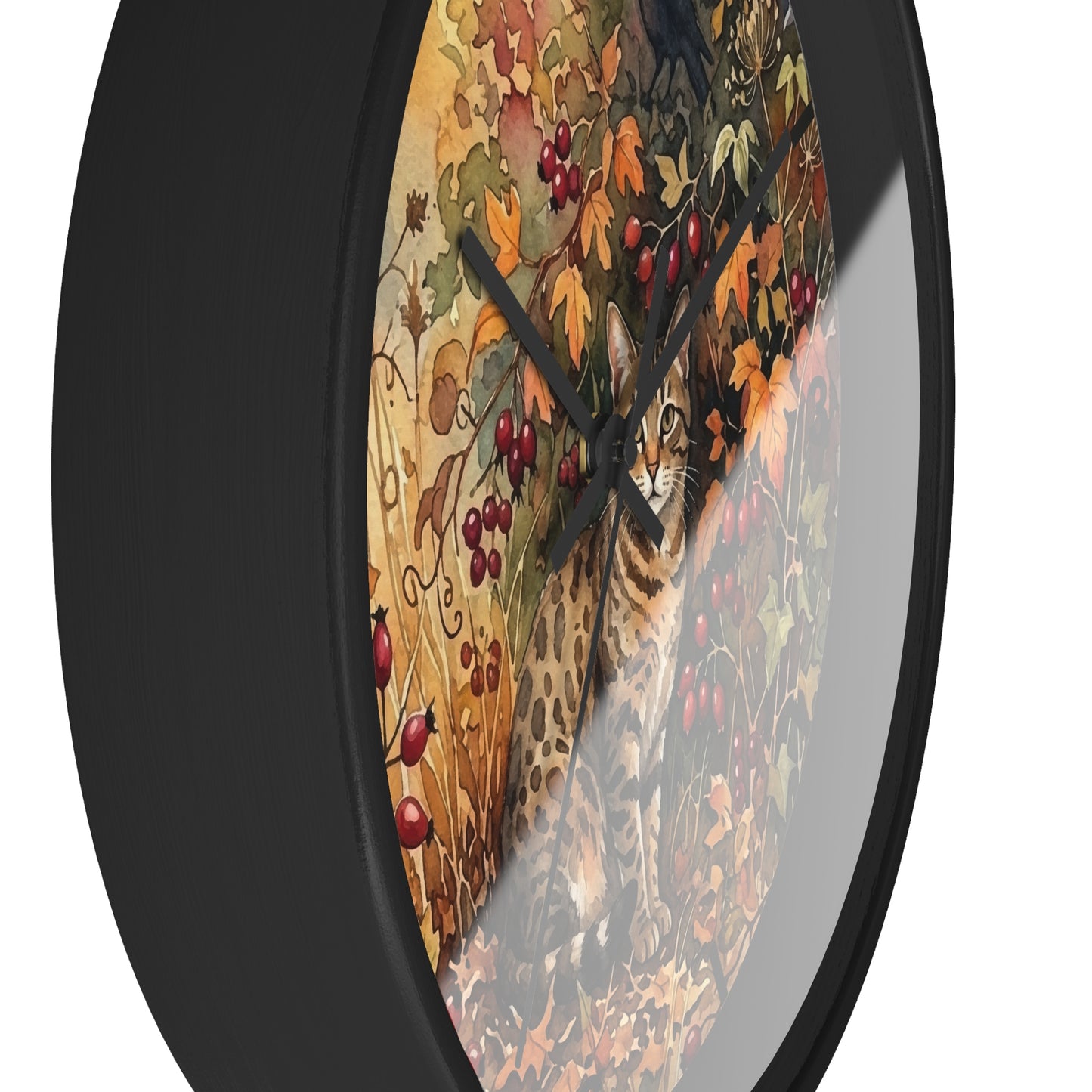 Round wall clock with a black frame and a printed autumn scene featuring a spotted cat among leaves and red berries, shown on a white background.