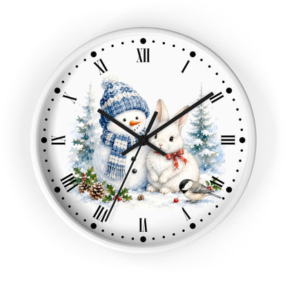 A round white wall clock with a winter holiday illustration featuring a snowman in a blue knit hat, a white rabbit with a red bow, evergreen trees, pinecones, and a small bird. The clock face has black Roman numerals, black minute markers with dots, and black hands.