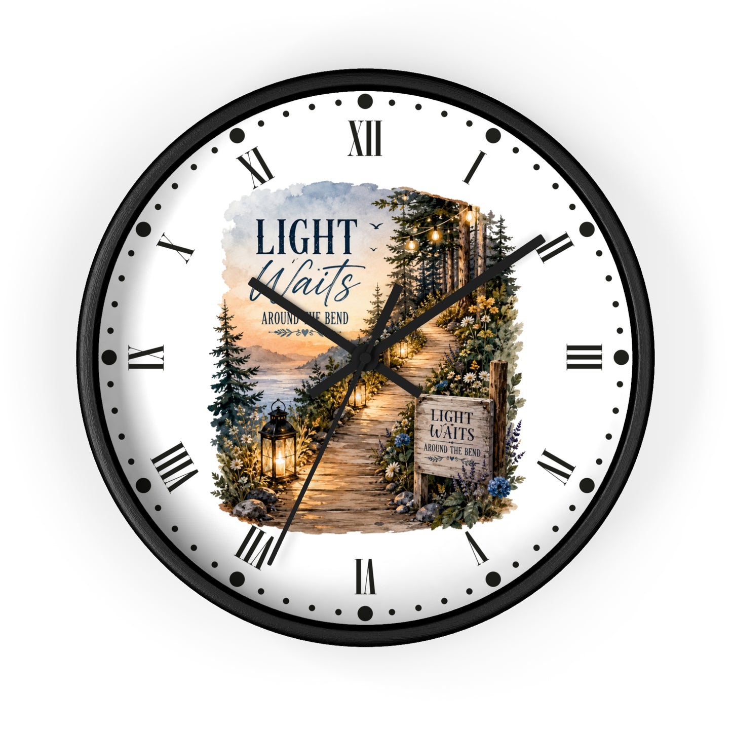 A round wall clock with a black frame and a white face featuring a scenic forest path illustration and the text 'LIGHT Waits AROUND THE Bend' .' Roman numerals mark the hours, with black hands and a small central decorative inset.