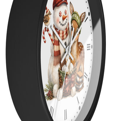 A round wall clock with a black frame and a white face featuring a festive illustration of a snowman, a deer, a bird, and holiday accessories.