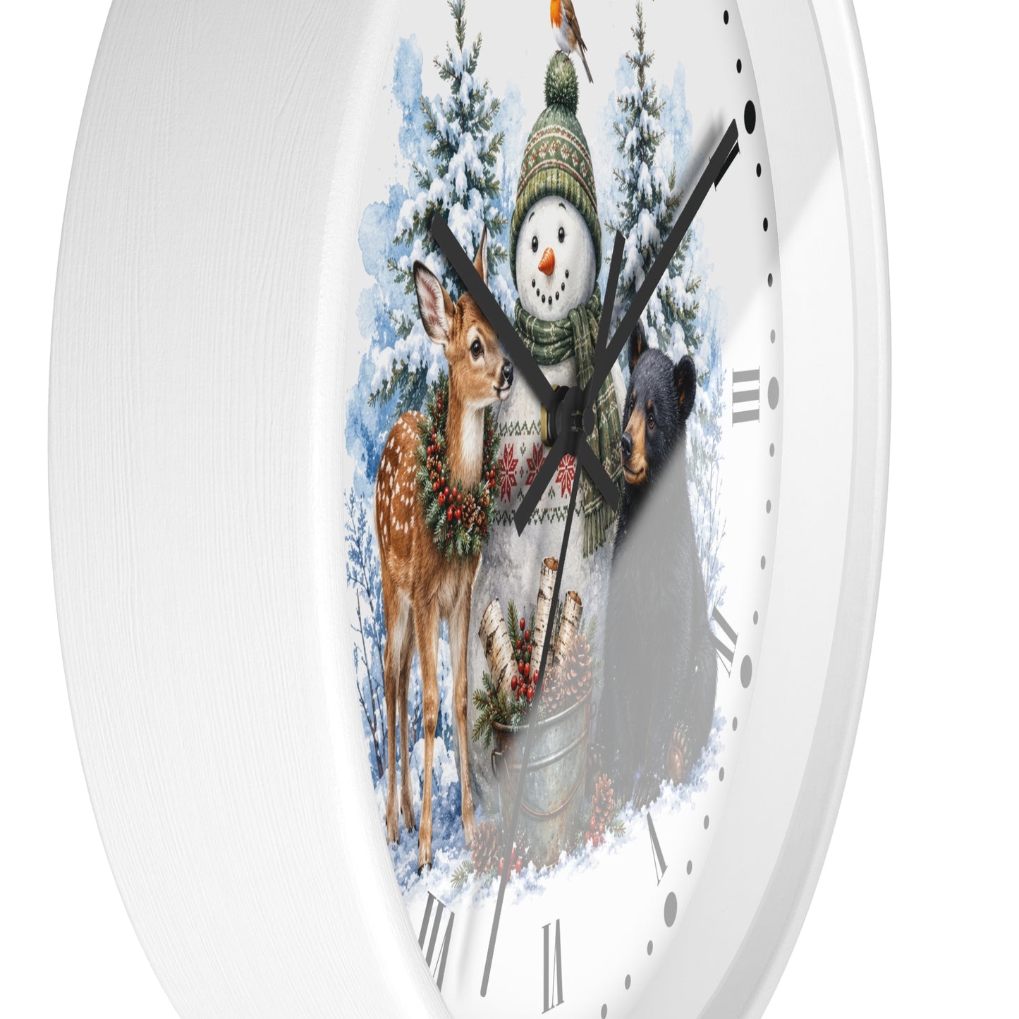 A white round wall clock with a festive winter illustration on the face, featuring a snowman in a green hat, a deer with a wreath, a bear, and snowy trees. The clock is shown against a clean white background.