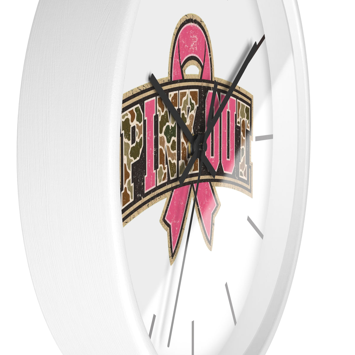 A white round wall clock with a bold graphic design in the center featuring a pink ribbon and the word 'PINK OUT' in a leopard-print patterned banner, set against a clean white background.