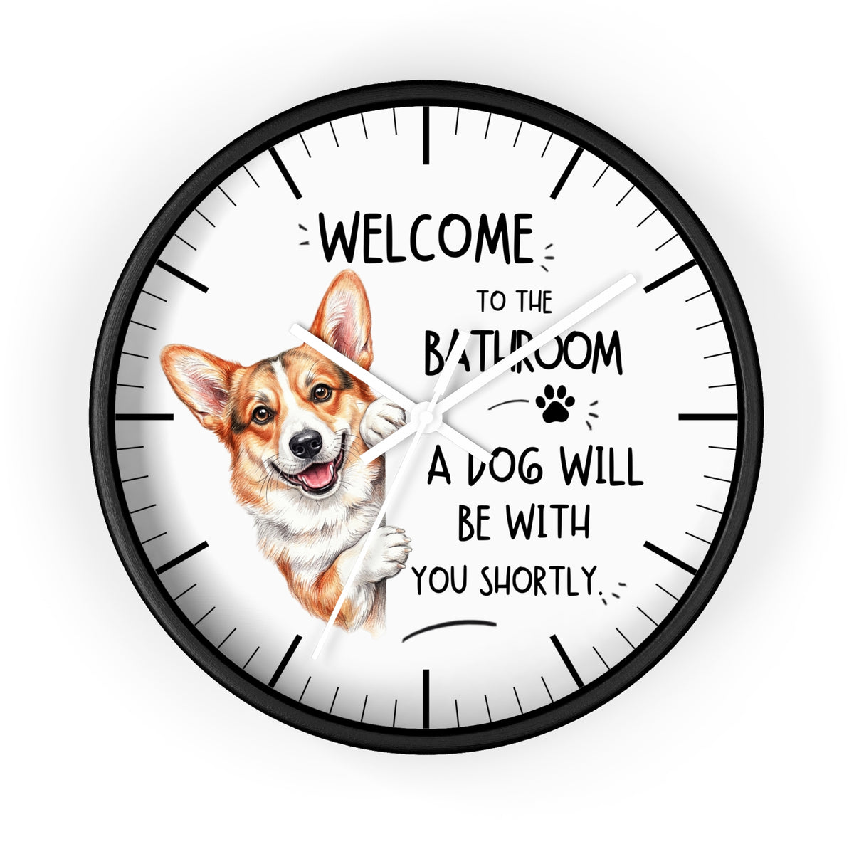 A round wall clock with a black frame and white face, featuring a cartoon Corgi illustration and the humorous text 'WELCOME TO THE BATHROOM A DOG WILL BE WITH YOU SHORTLY'.