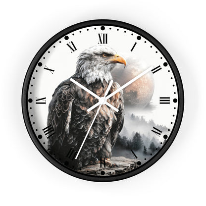 A round wall clock with a black frame and a printed design of a bald eagle over a misty forest and moon, with Roman numerals and white hands on a white face.