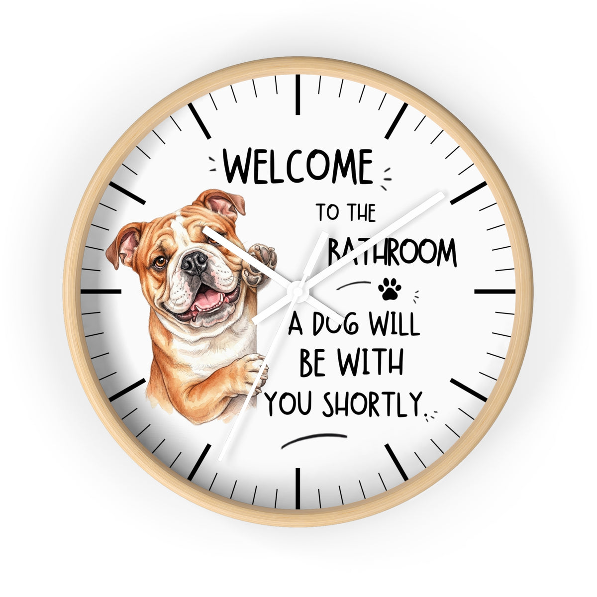 A round wall clock with a light wood frame and a white face, featuring a brown and white bulldog illustration and the text 'WELCOME TO THE BATHROOM A DOG WILL BE WITH YOU SHORTLY.' on a plain white background.