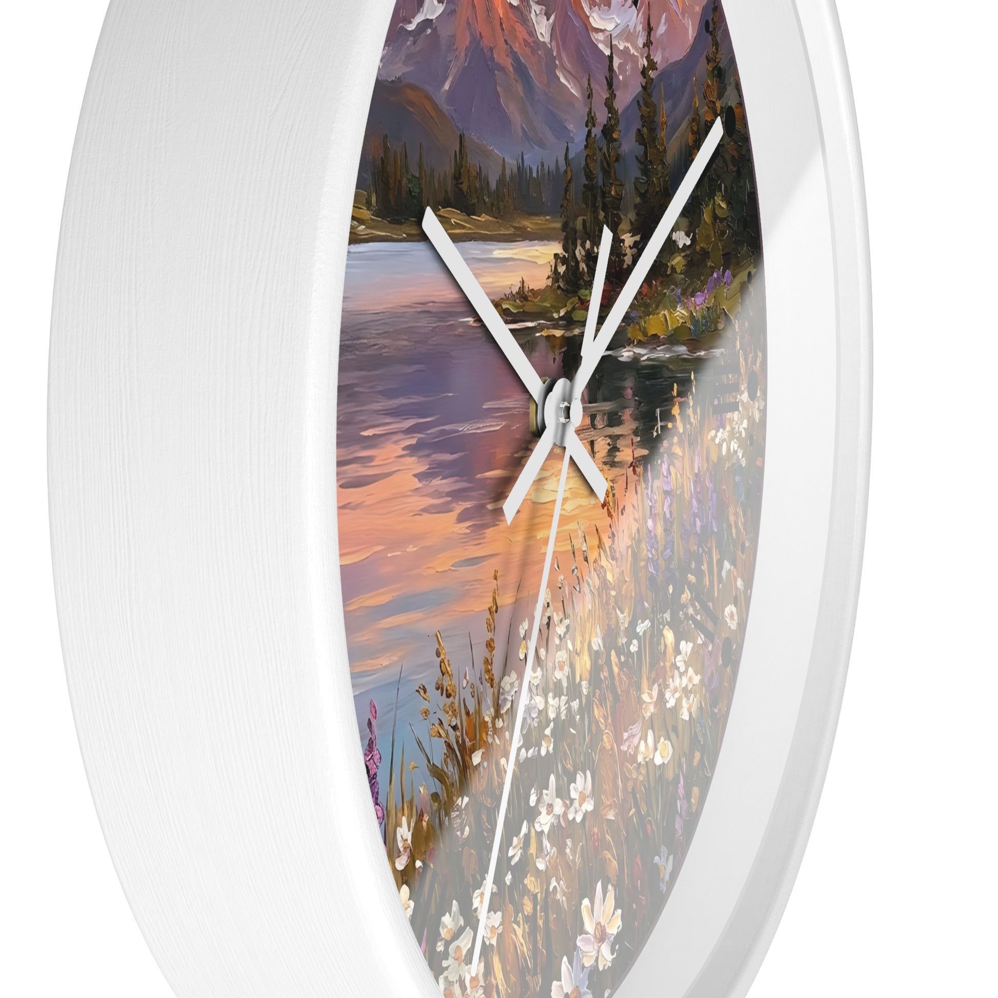 Round wall clock with a white frame and a scenic landscape print featuring a river, mountains, trees, and wildflowers. The clock face is partially visible behind the white bezel, with white hands and a thin second hand.