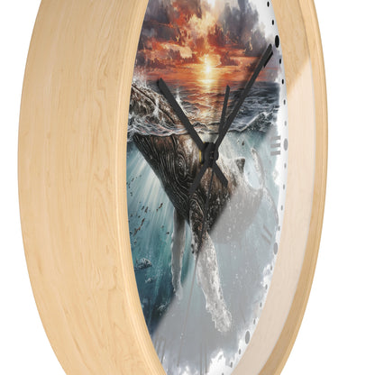 Round wall clock with a light natural wood frame and a printed ocean scene featuring a whale, waves, and a dramatic sunset on the dial, shown against a plain white background.