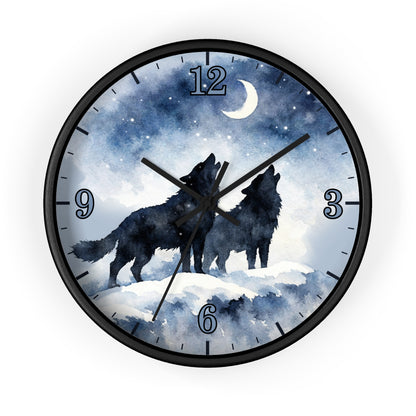 Round wall clock with a black frame and a printed night sky face showing two black howling wolves under a crescent moon and stars. The clock has blue-toned watercolor-style background, black numerals, and black hands on a white studio background.