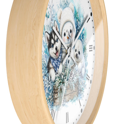 A round wall clock with a light natural wood frame and a white face featuring a winter illustration of a husky, a snowman, and a puppy in blue snowy foliage.