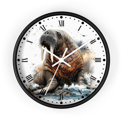 A round wall clock with a black frame and a printed design of a walrus sitting on rocks in the water, with Roman numerals and white clock hands on a white face.