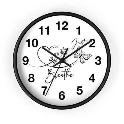 Wall clock with black frame and white face displaying the time and a motivational quote "Just Breath" with butterflies.