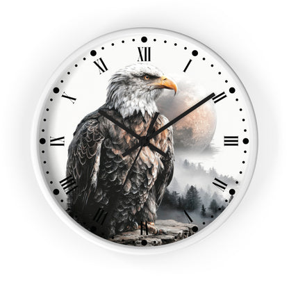 Round wall clock with a white face featuring a large bald eagle in front of a moon and misty forest scene, with black Roman numerals and clock hands on a white background.