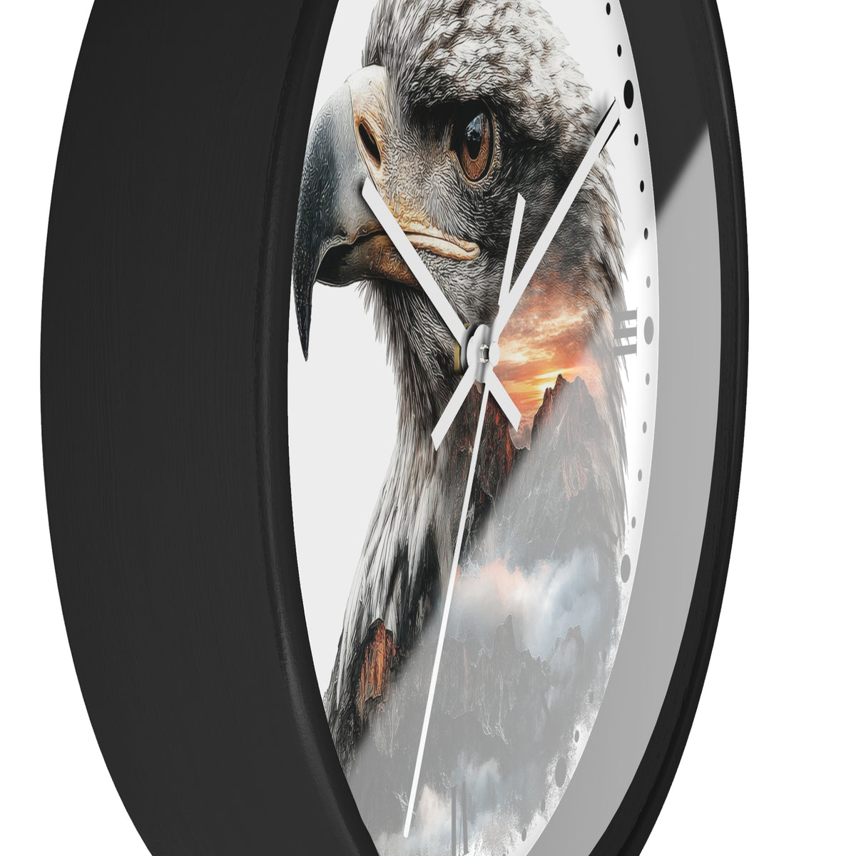 A close-up of a round wall clock with a black frame and a printed design featuring a large eagle head over a mountain landscape at sunset.