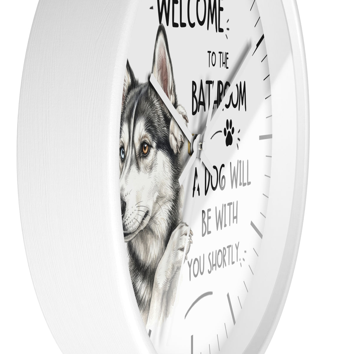 A round white wall clock with a printed illustration of a husky dog and the text 'WELCOME TO THE BATROOM A DOG WILL BE WITH YOU SHORTLY' on the front.