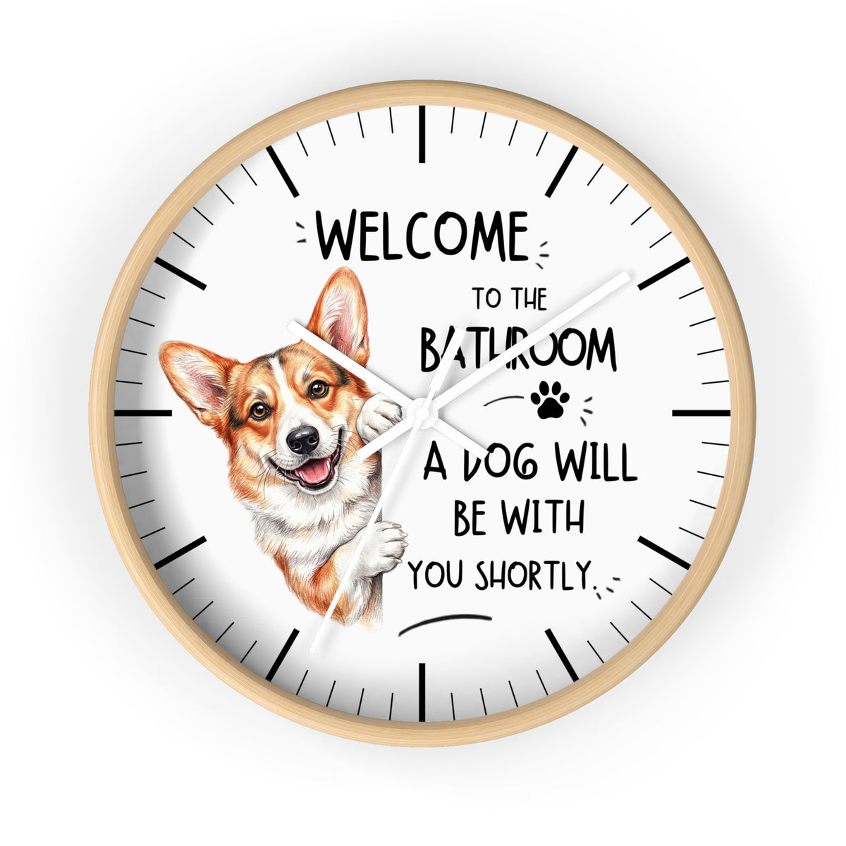 A round wall clock with a light wood frame and a white face, featuring a cartoon Corgi illustration and the text 'WELCOME TO THE BATHROOM A DOG WILL BE WITH YOU SHORTLY.' on a plain white background.