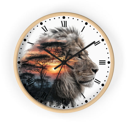 A round wall clock with a light wood frame and a white face featuring a photographic lion profile layered over an African savanna sunset scene with trees. The clock has black Roman numerals, black hands, and black dot hour markers on a clean white background.
