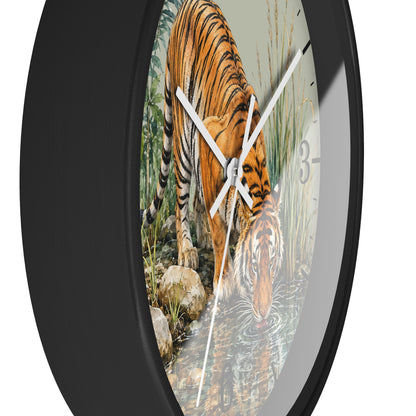 Round wall clock with a black frame and a printed tiger drinking water scene on the face, shown against a plain white background.
