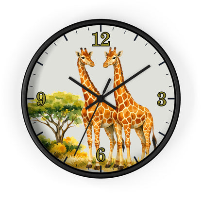 A round wall clock with a black frame and a safari-themed dial featuring two giraffes, a tree, and gold Arabic numerals on a light background.