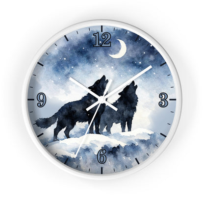 A round wall clock with a white frame and a watercolor-style night sky face showing two black howling wolves under a crescent moon and stars. The clock has black Arabic numerals for hours and white hands.