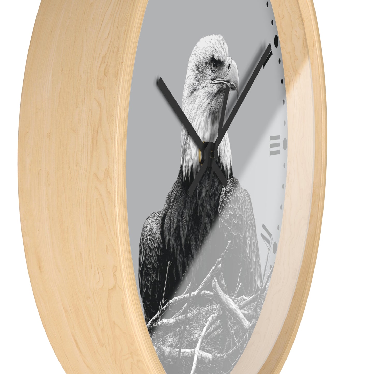 Round wall clock with a light natural wood frame and a grayscale eagle print on the face, with black hands and Roman numeral markers.