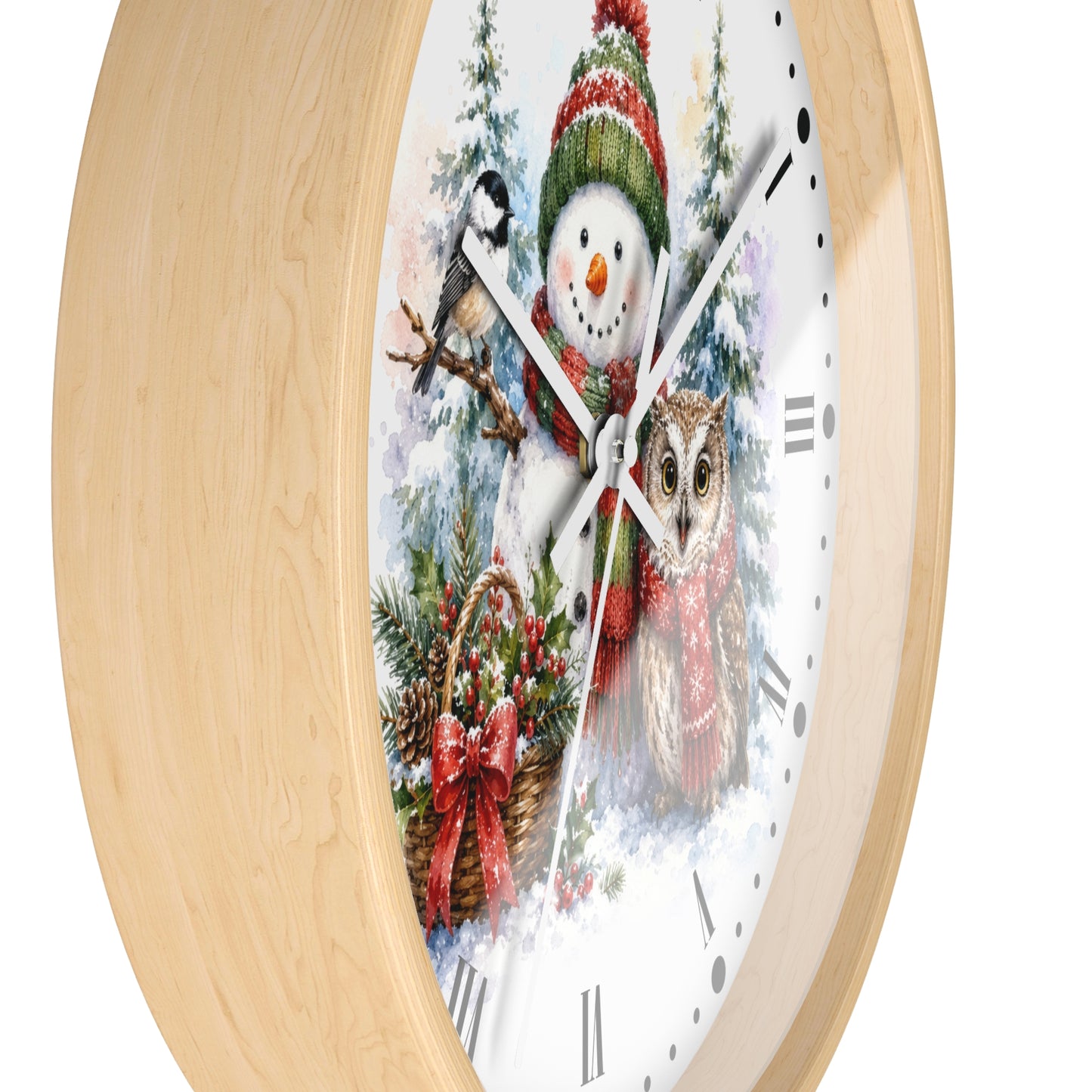 A round wall clock with a light natural wood frame and a white face featuring a winter holiday illustration of a snowman, a bird, an owl, evergreen branches, and a red bow.