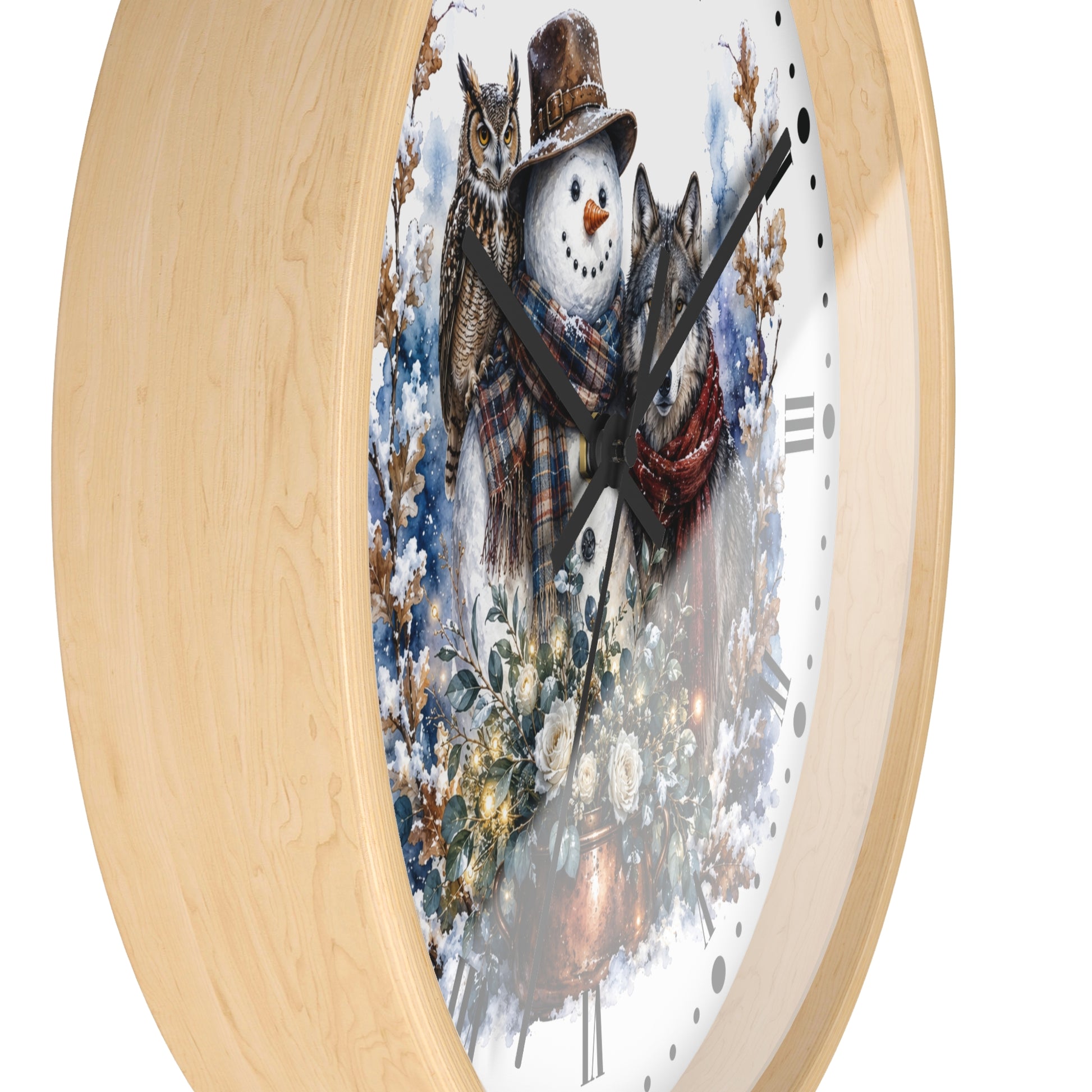 A round wall clock with a light natural wood frame and a white face featuring a winter illustration of a snowman, an owl, and a wolf in a snowy outdoor scene.