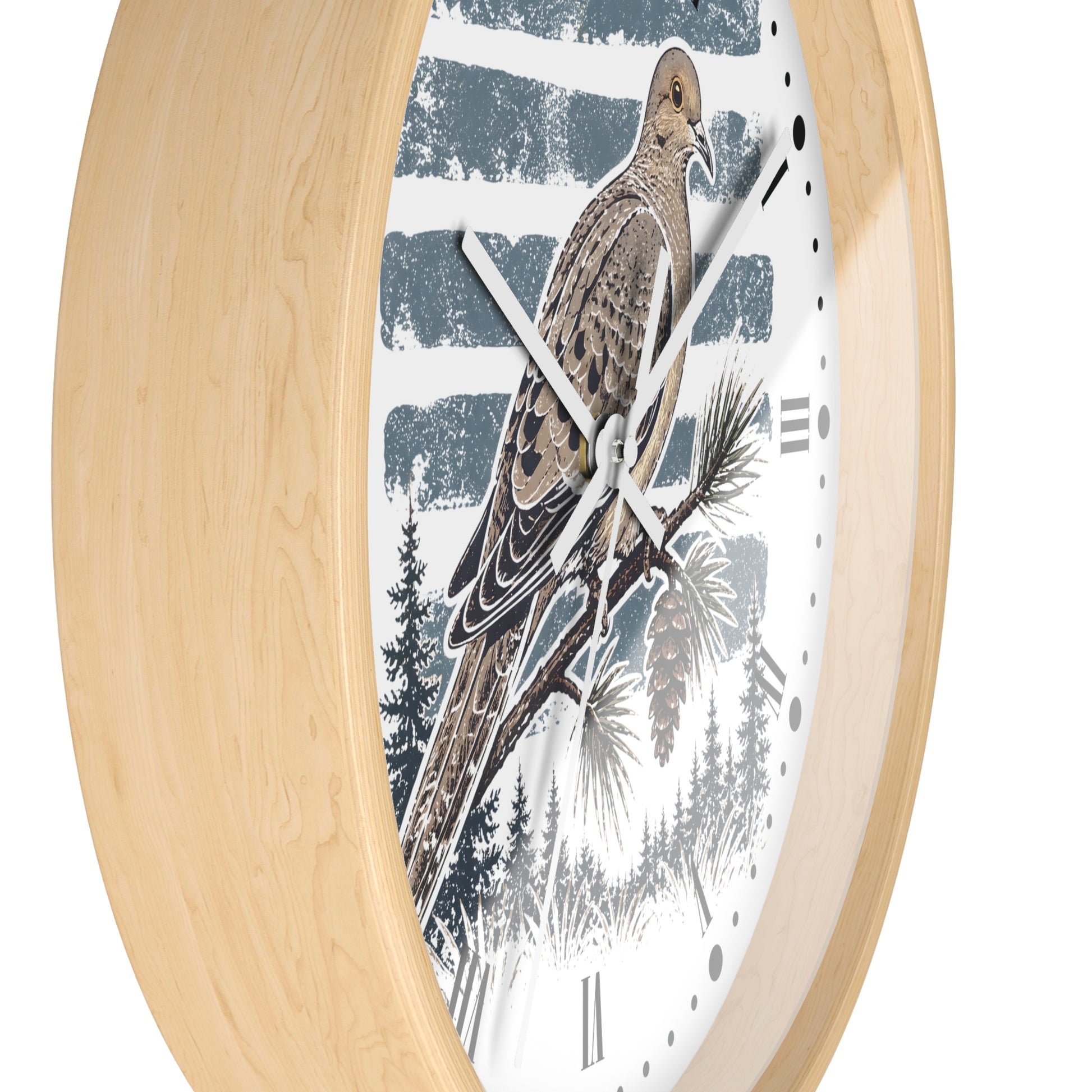 A close-up of a wall clock with a light natural wood frame and a white dial featuring a detailed illustration of a brown dove bird perched on a pine branch against a blue-gray striped background.