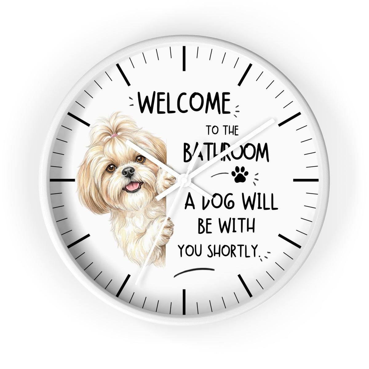 A round white wall clock with black hands and hour markers, featuring a printed illustration of a small fluffy dog and the text 'WELCOME TO THE BATHROOM A DOG WILL BE WITH YOU SHORTLY.' on a white background.