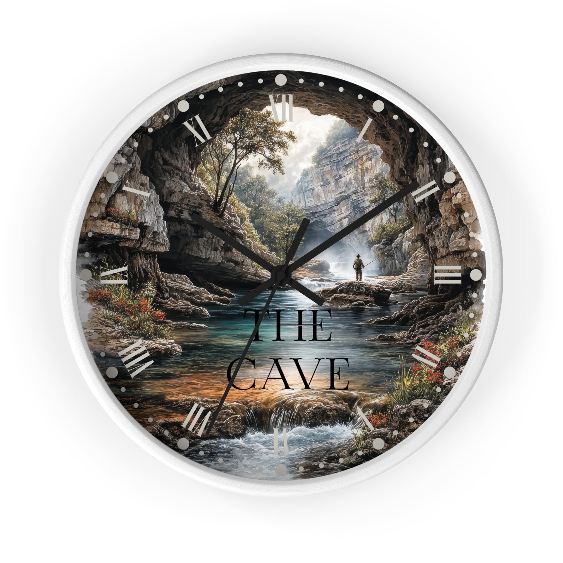 A round wall clock with a white frame and a scenic cave landscape printed on the face. The artwork shows rocky cave walls, a stream, trees, and a small figure standing by the water.