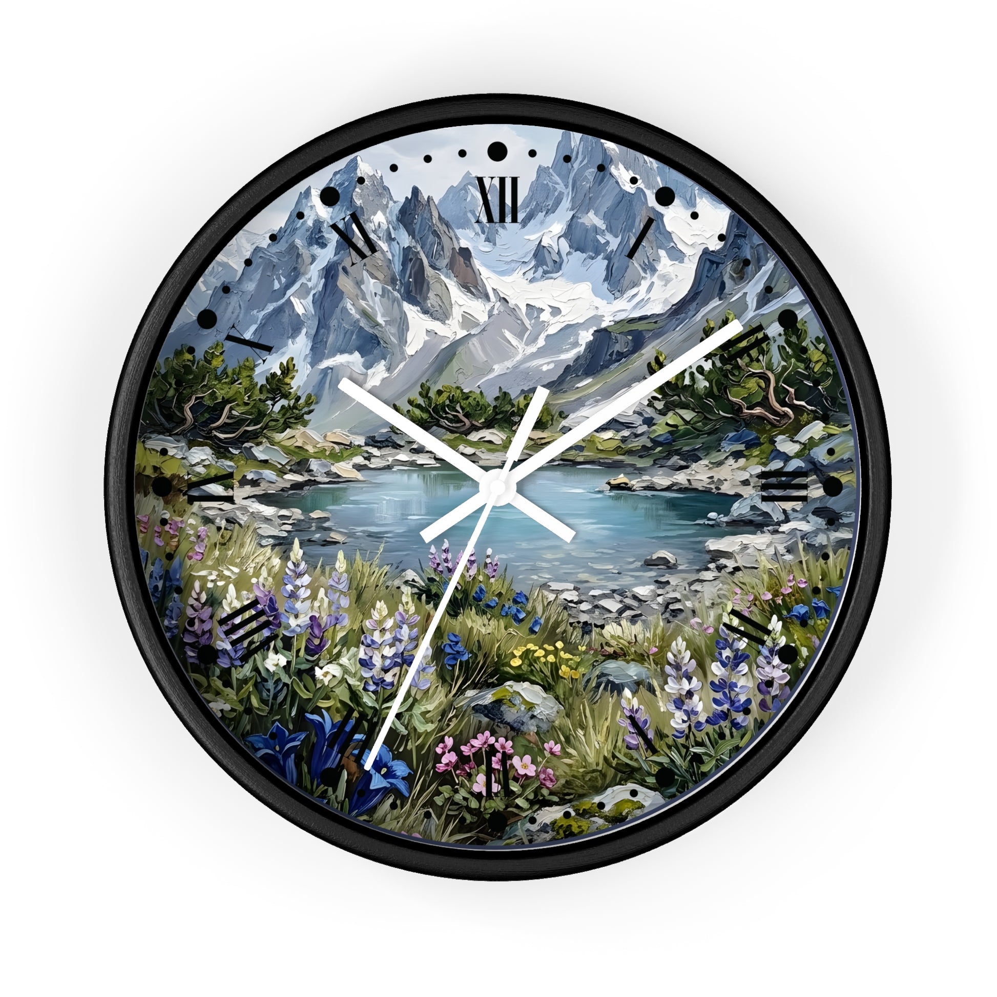 A round wall clock with a black frame and a scenic mountain landscape printed on the face. The artwork shows snow-capped blue-gray mountains, a lake, green trees, and wildflowers in the foreground.
