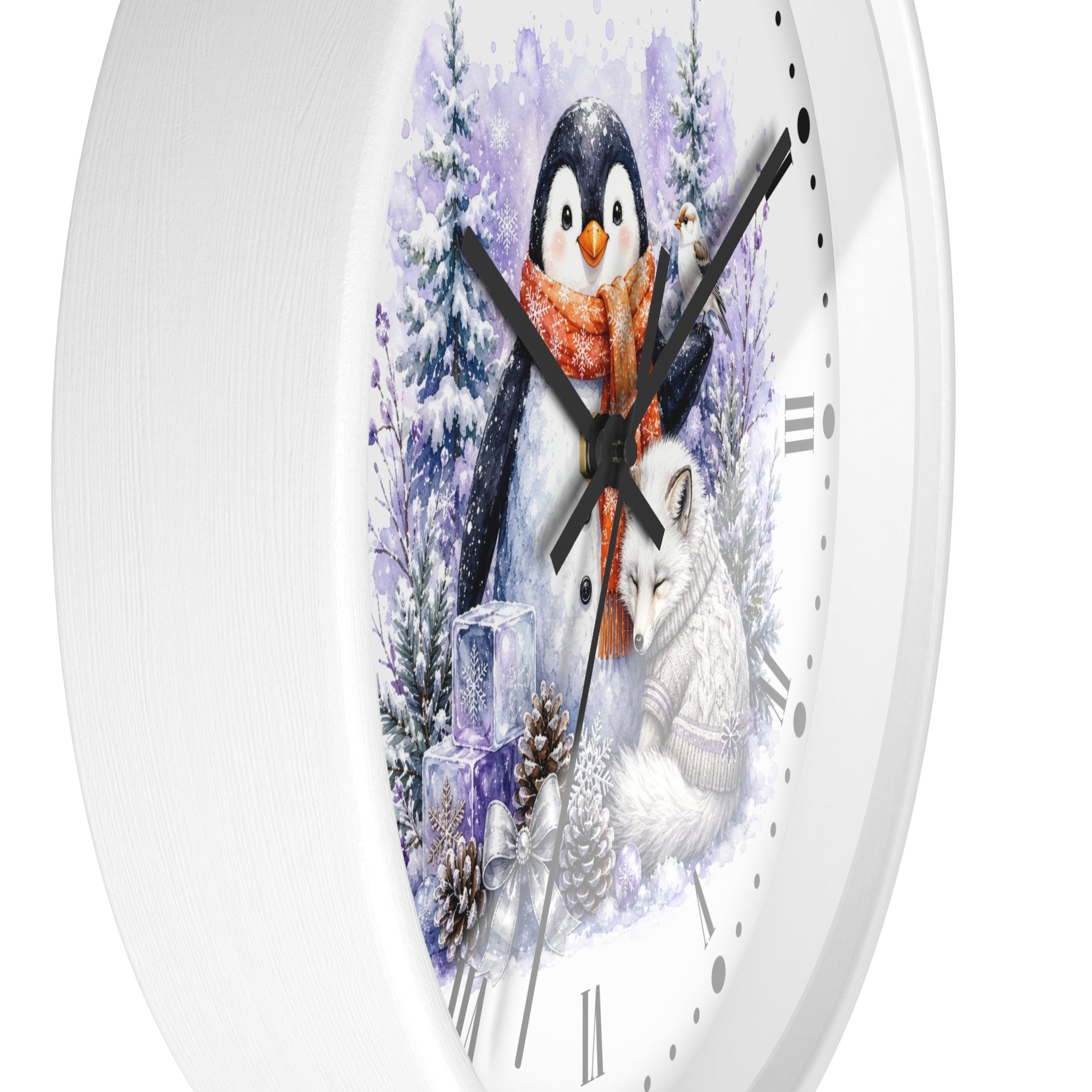 A white round wall clock with a winter-themed illustration on the face, featuring a penguin in a red scarf, a white fox, snowy trees, and pinecones.