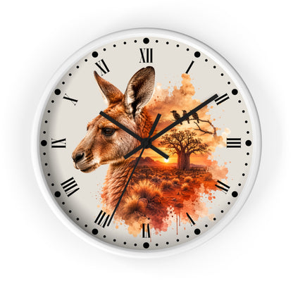 A round wall clock with a white frame and a printed dial featuring a kangaroo head, a tree, birds, and an orange sunset scene. The clock has black Roman numerals and black hands on a white background.