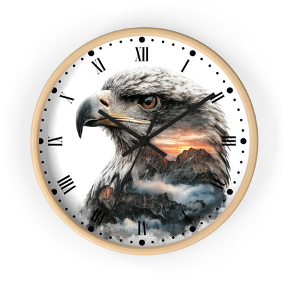 Round wall clock with a light wood frame and a white face featuring a large eagle head over a mountain sunset scene, with black Roman numerals and hands on a white background.