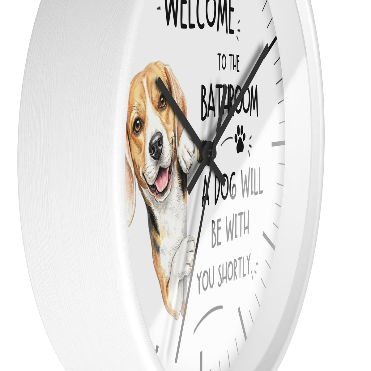 A round white wall clock with a humorous pet quote and a painted beagle illustration. The text reads 'WELCOME TO THE BATHROOM A DOG WILL BE WITH YOU SHORTLY' with a paw print, displayed against a clean white background.