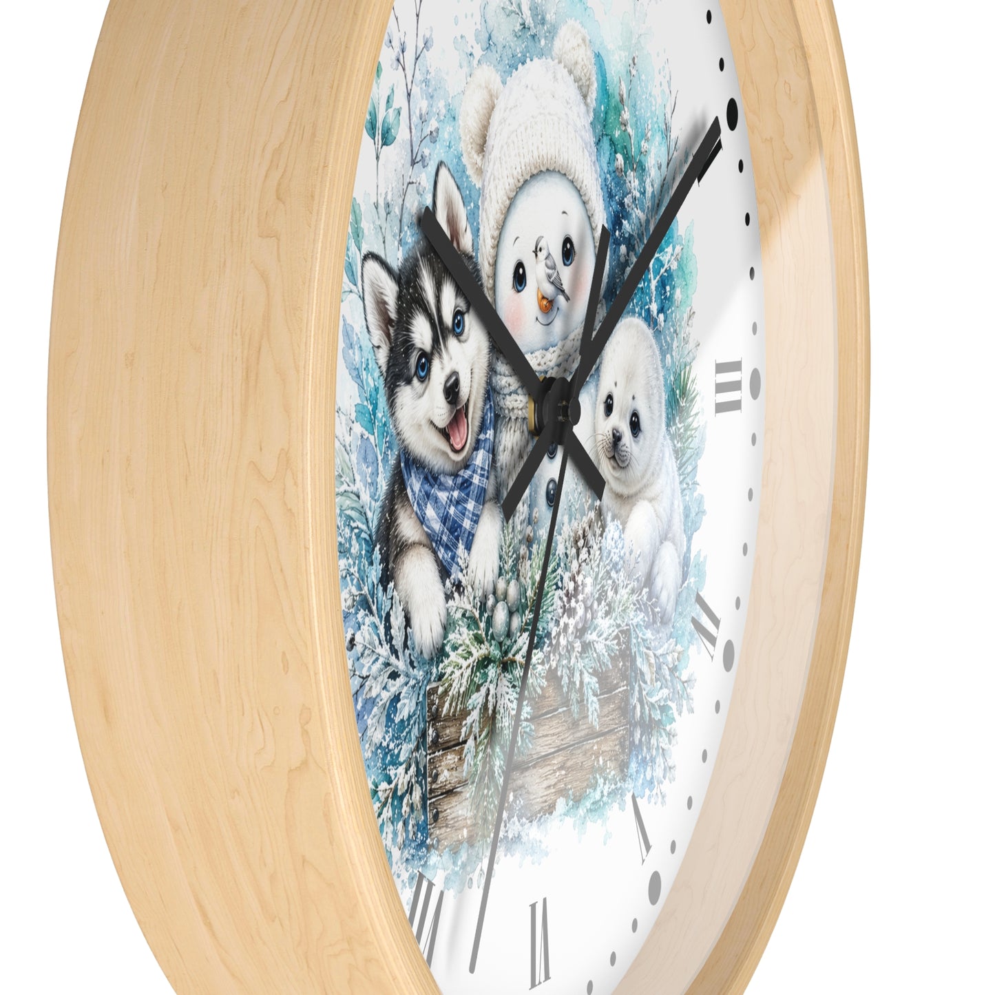 A round wall clock with a light natural wood frame and a printed winter illustration on the face, showing a husky, a snowman, and a puppy in snowy scenery. The clock is photographed against a plain white background.