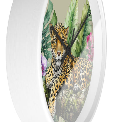 Round wall clock with a white frame and a printed tropical jungle scene featuring a leopard, large green leaves, and pink flowers.
