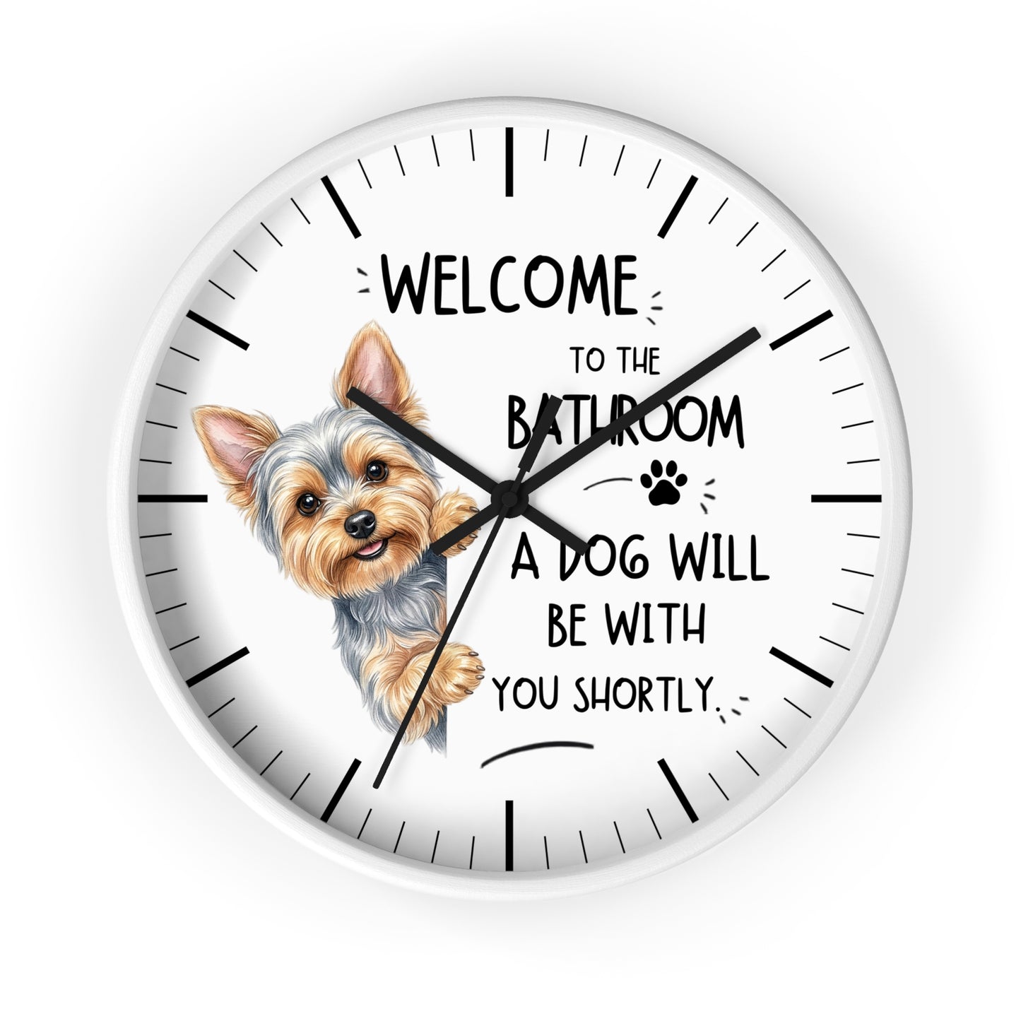 A round white wall clock with black hands and hour markers, featuring a cartoon Yorkshire Terrier illustration and the text 'WELCOME TO THE BATHROOM A DOG WILL BE WITH YOU SHORTLY.' on a white background.