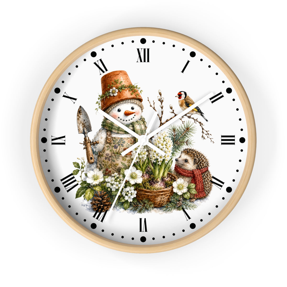 A round wall clock with a light wood frame and a white face featuring a whimsical winter garden illustration. The design includes a snowman in a terracotta pot hat, a small bird, a hedgehog in a red scarf, white flowers, pinecones, and Roman numerals with black dot hour markers.