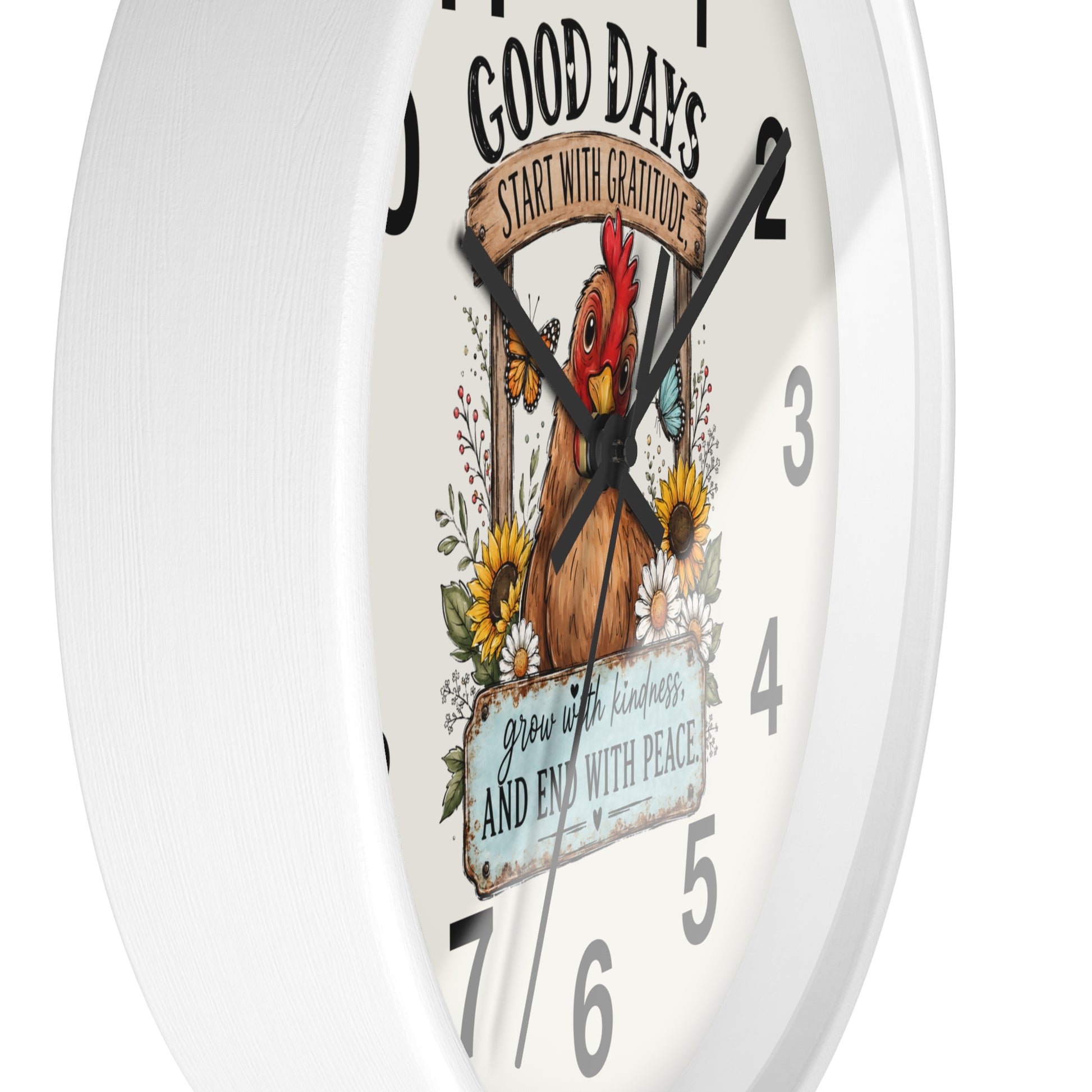 A white round wall clock with a printed chicken-themed quote design on the face, including the text 'GOOD DAYS START WITH GRATITUDE' and 'grow with kindness and END with peace.'.