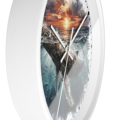 A white round wall clock with a printed ocean scene featuring a whale, waves, and a dramatic sunset on the dial, shown against a plain white background.
