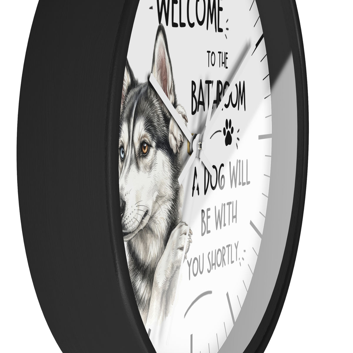 A round wall clock with a black frame and a white face featuring a husky illustration and the text 'WELCOME TO THE BATROOM A DOG WILL BE WITH YOU SHORTLY'.