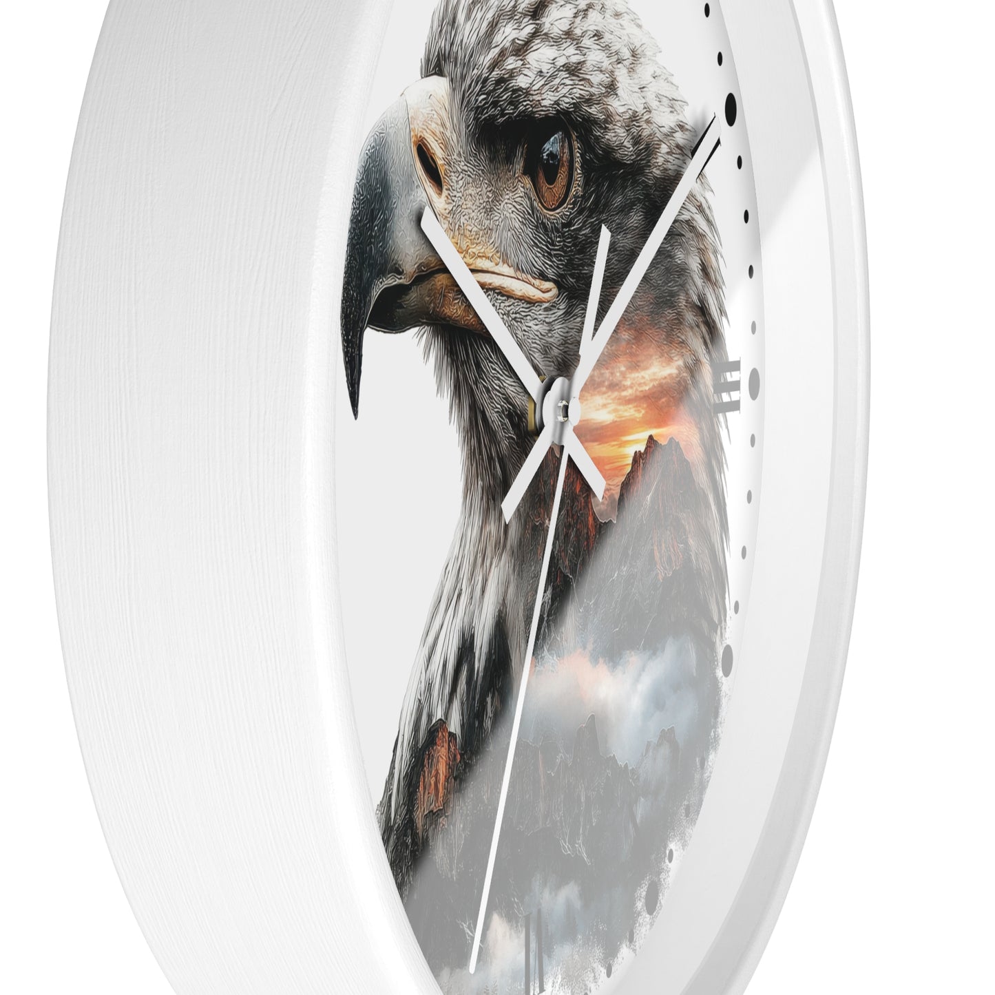 A close-up of a round wall clock with a white frame and a printed design of a large eagle over a mountain landscape at sunset.