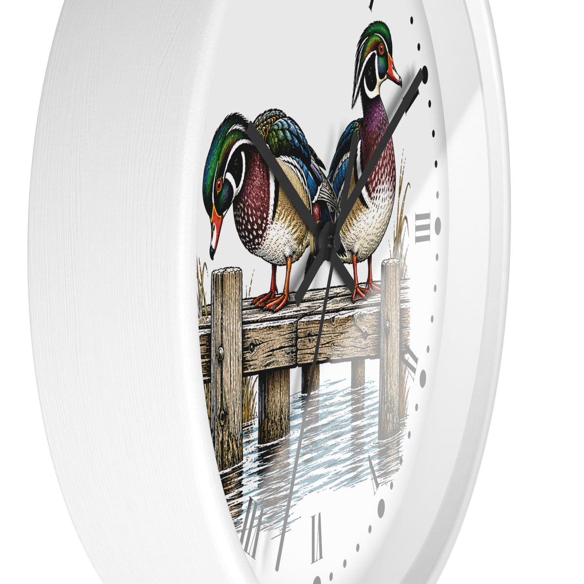 A white round wall clock with a printed illustration of three wood ducks standing on a wooden dock over water, with black Roman numerals and black hands.