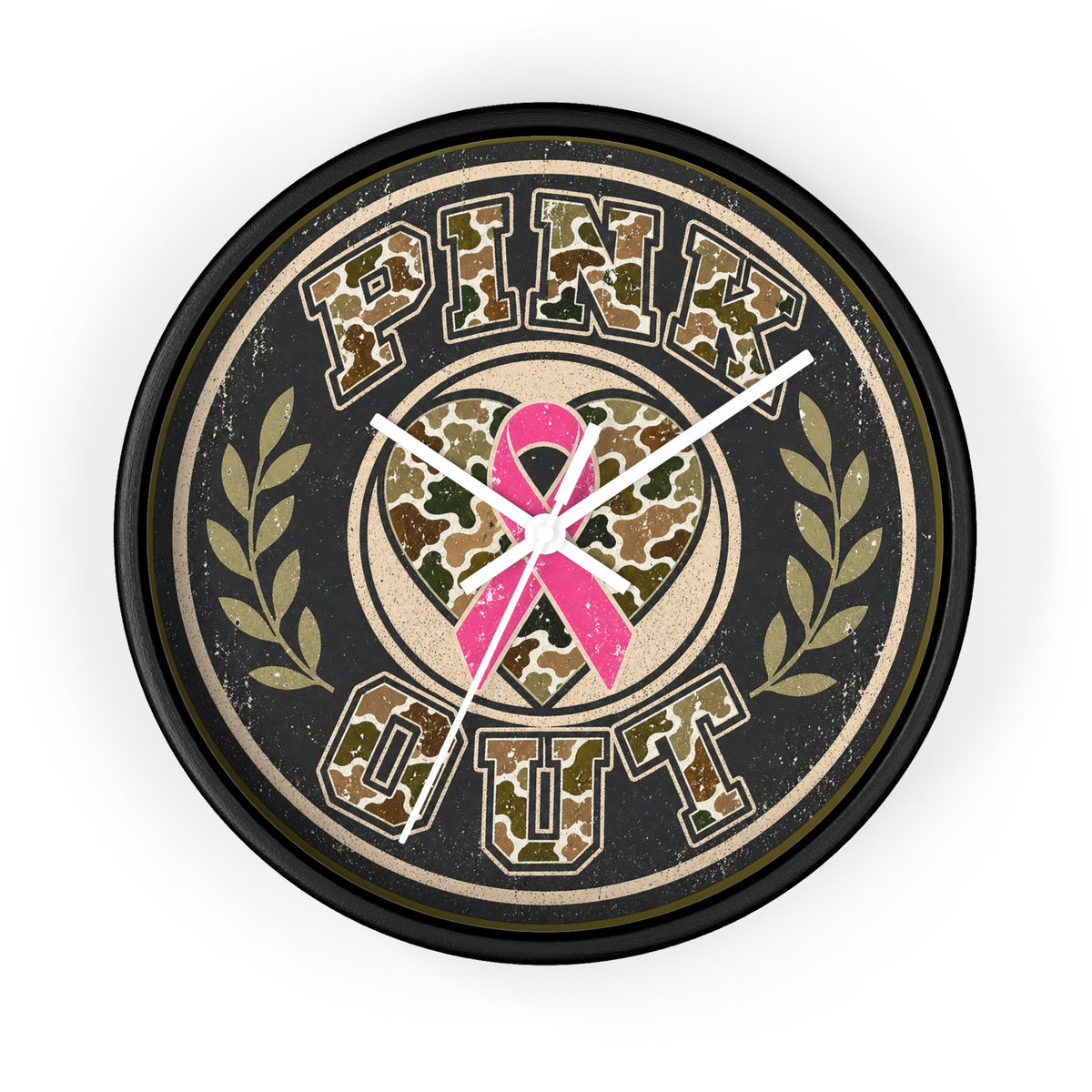 A round wall clock with a black frame and a distressed design featuring the words 'PINK OUT' in camouflage lettering, a pink ribbon heart in the center, and olive green laurel branches on a light gray background.