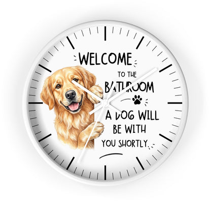 A round white wall clock with a golden retriever illustration and the text 'WELCOME TO THE BATHROOM A DOG WILL BE WITH YOU SHORTLY.' on a clean white background.