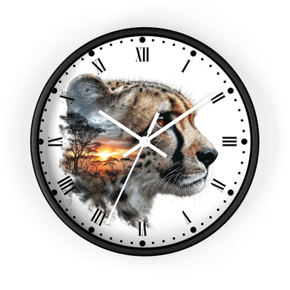 A round wall clock with a black frame and white face, featuring a photographic cheetah profile over a double-exposure landscape scene of an African savanna at sunset. The clock has black Roman numerals and white hands.