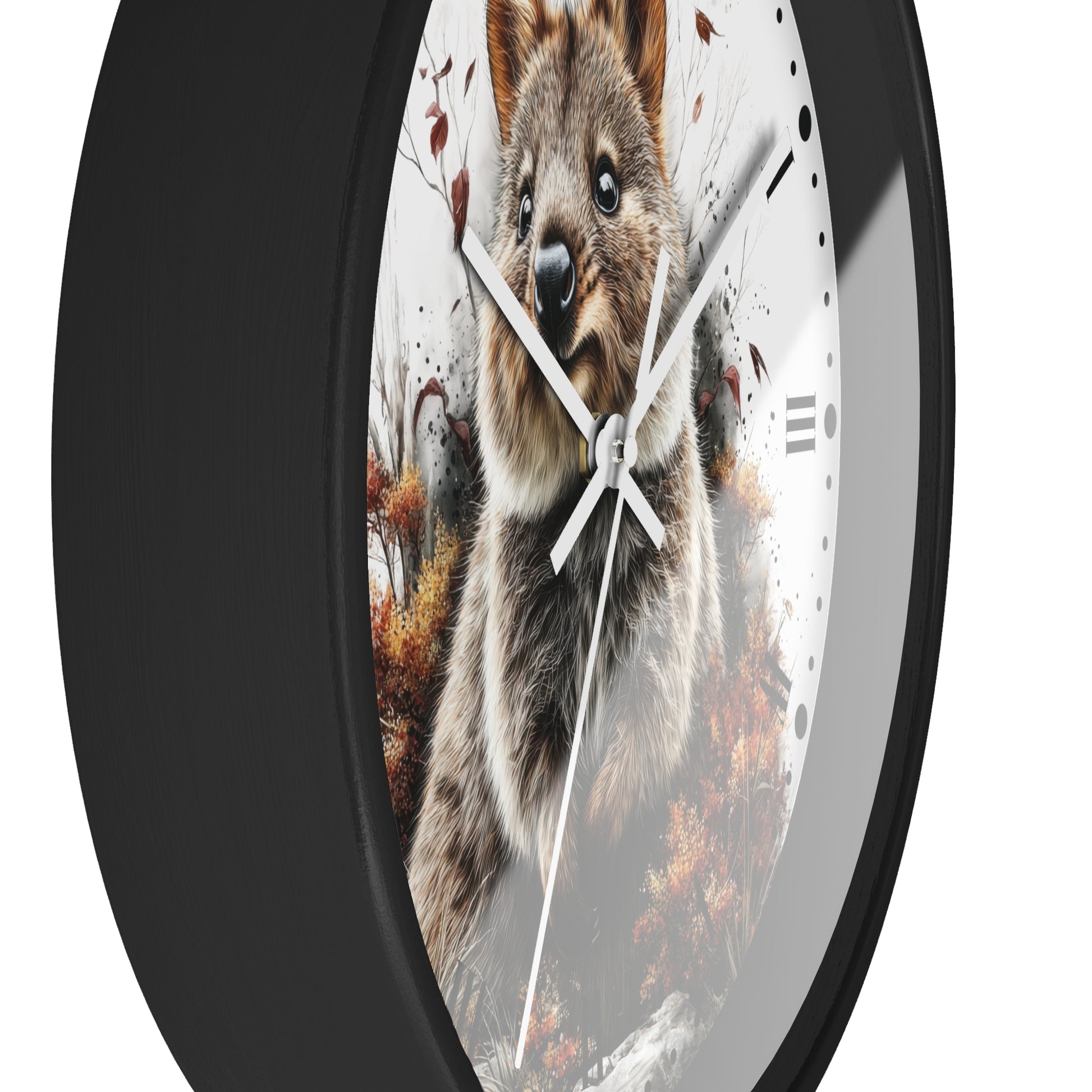 A round wall clock with a black frame and a printed quokka in autumn design on the face, with white hands and black hour markers, shown against a plain white background.