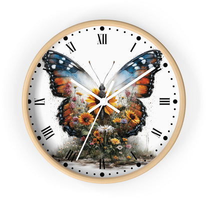 A round wall clock with a light wood frame and a white dial featuring a large colorful butterfly over wildflowers, with black Roman numerals and hands on a white background.